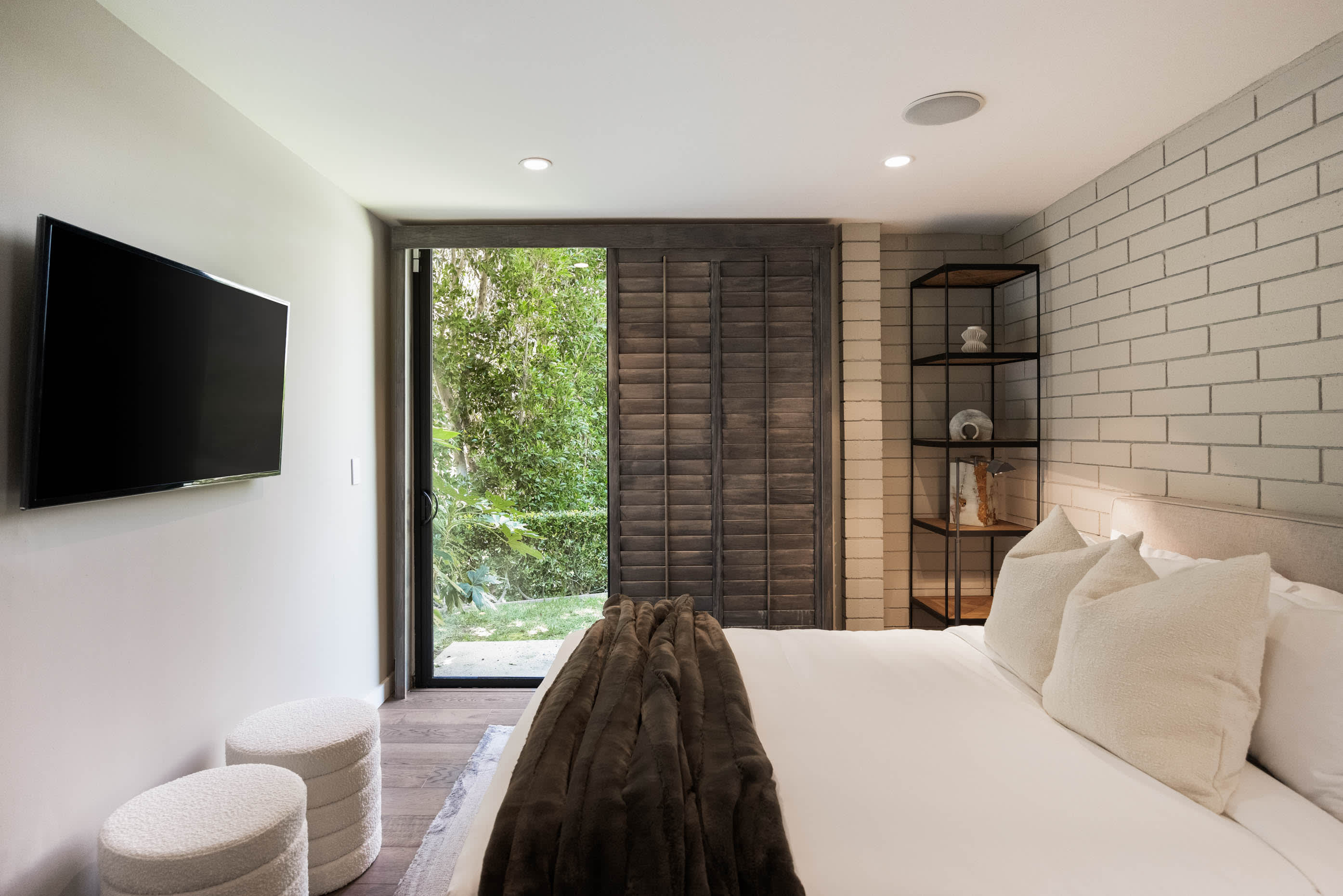 The bedroom sets the scene for relaxation with seamless access to the outdoor space.