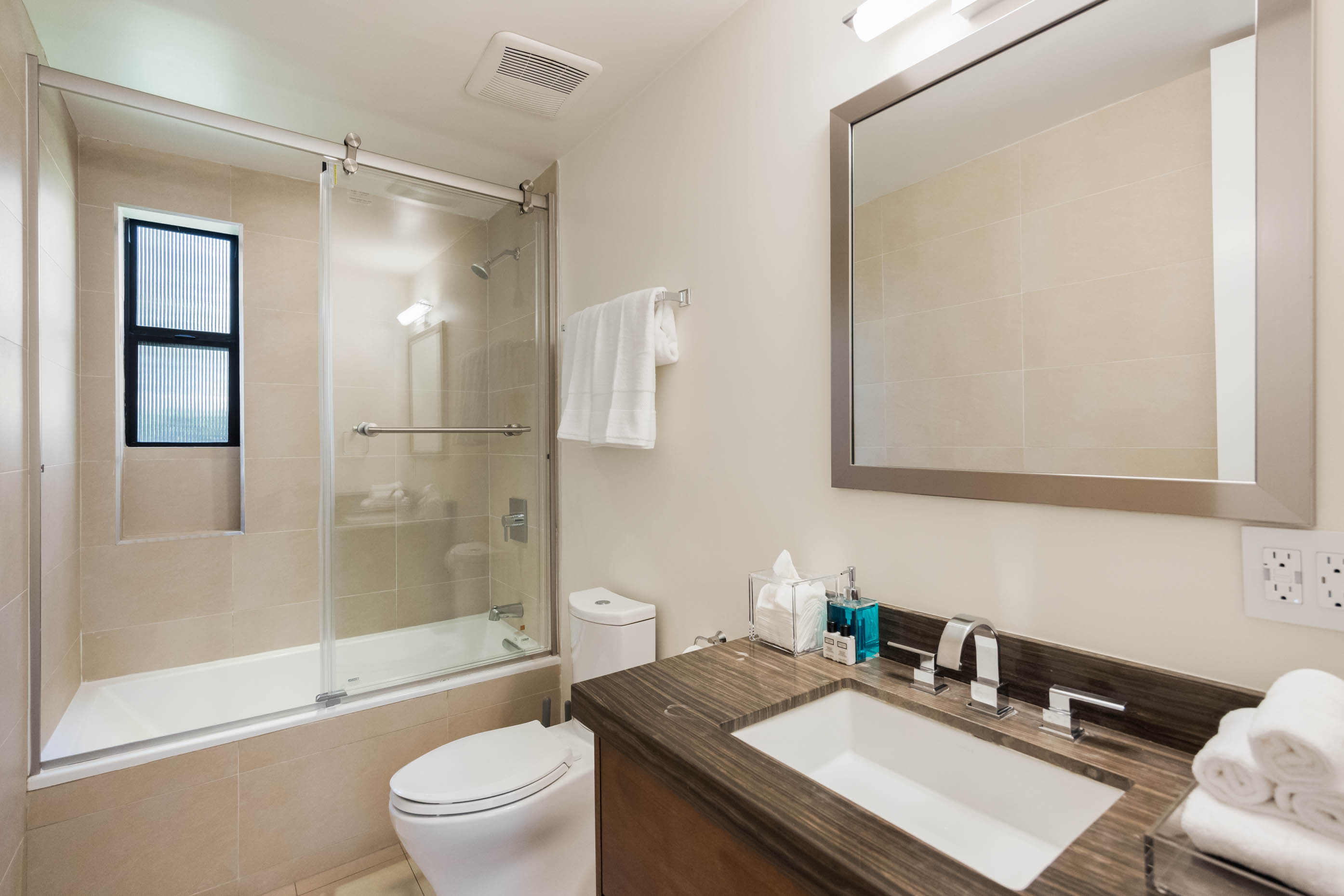 The bathroom is fully stocked with all essentials, including luxurious premium amenities and plush towels.