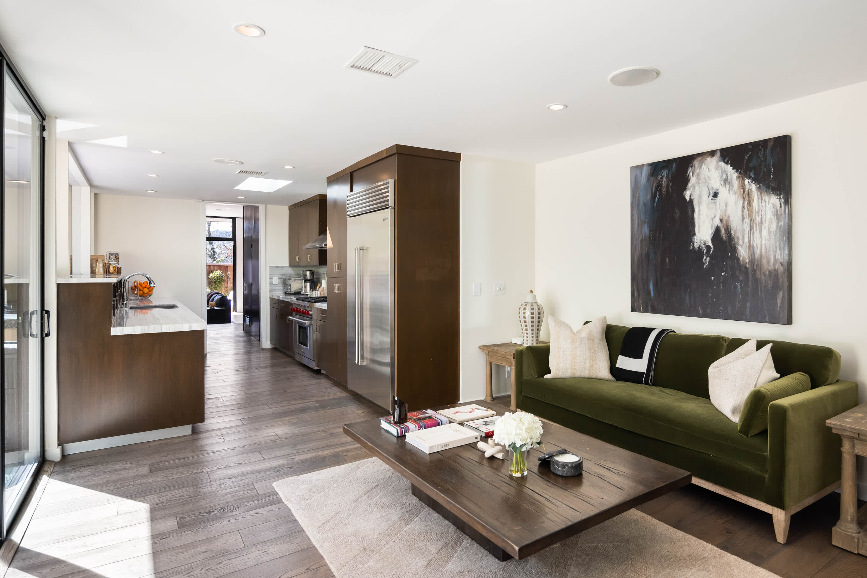 Relax in the additional seating area, complete with a TV and desk, offering the perfect spot to unwind or catch up on work.