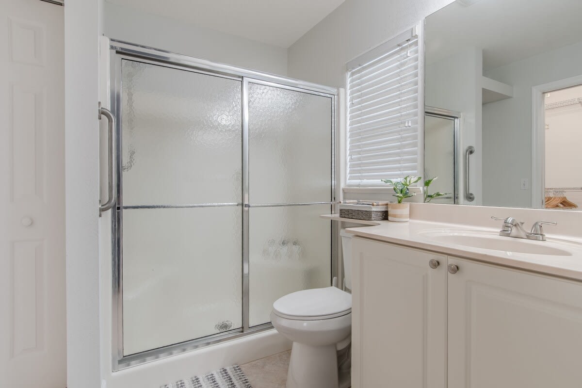 Bathroom 1 attached to king-sized bedroom and features a roomy shower.