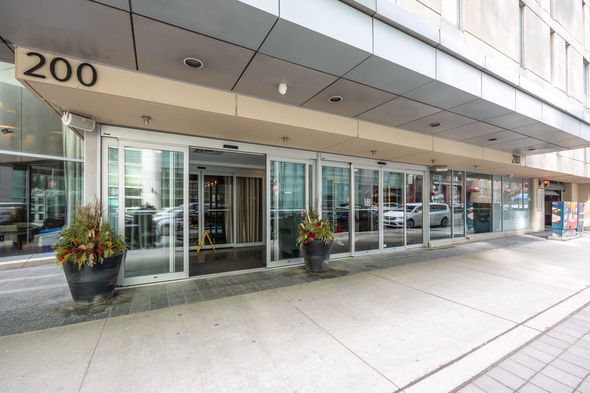 Stylish Building Entrance With Modern Glass Doors And Planters