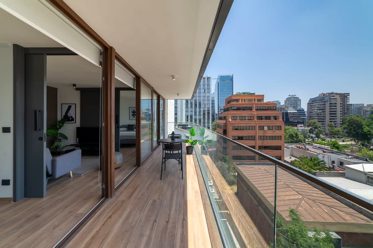 Enjoy breathtaking city views from this expansive private balcony, perfect for al fresco dining and relaxation.