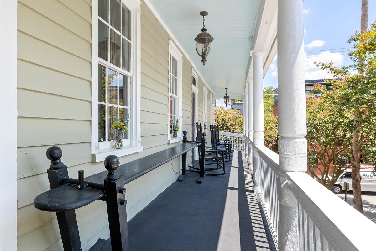 Outdoor balcony seating including a Charleston joggling board and rocking chairs!