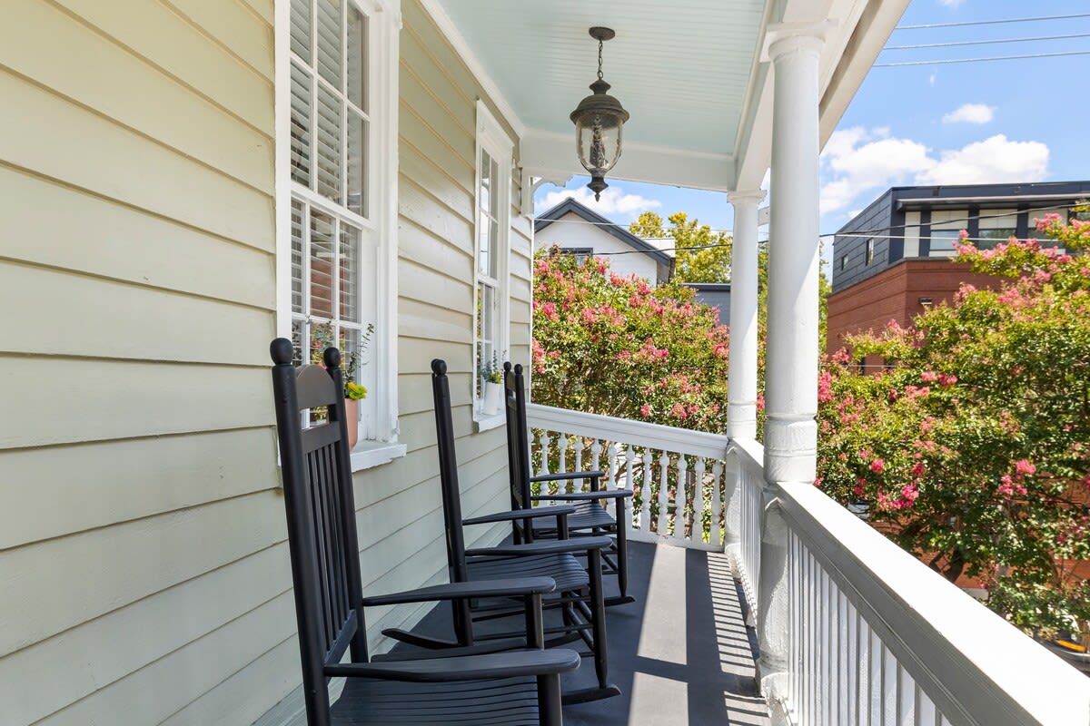 Outdoor balcony seating including rocking chairs and a Charleston joggling board!