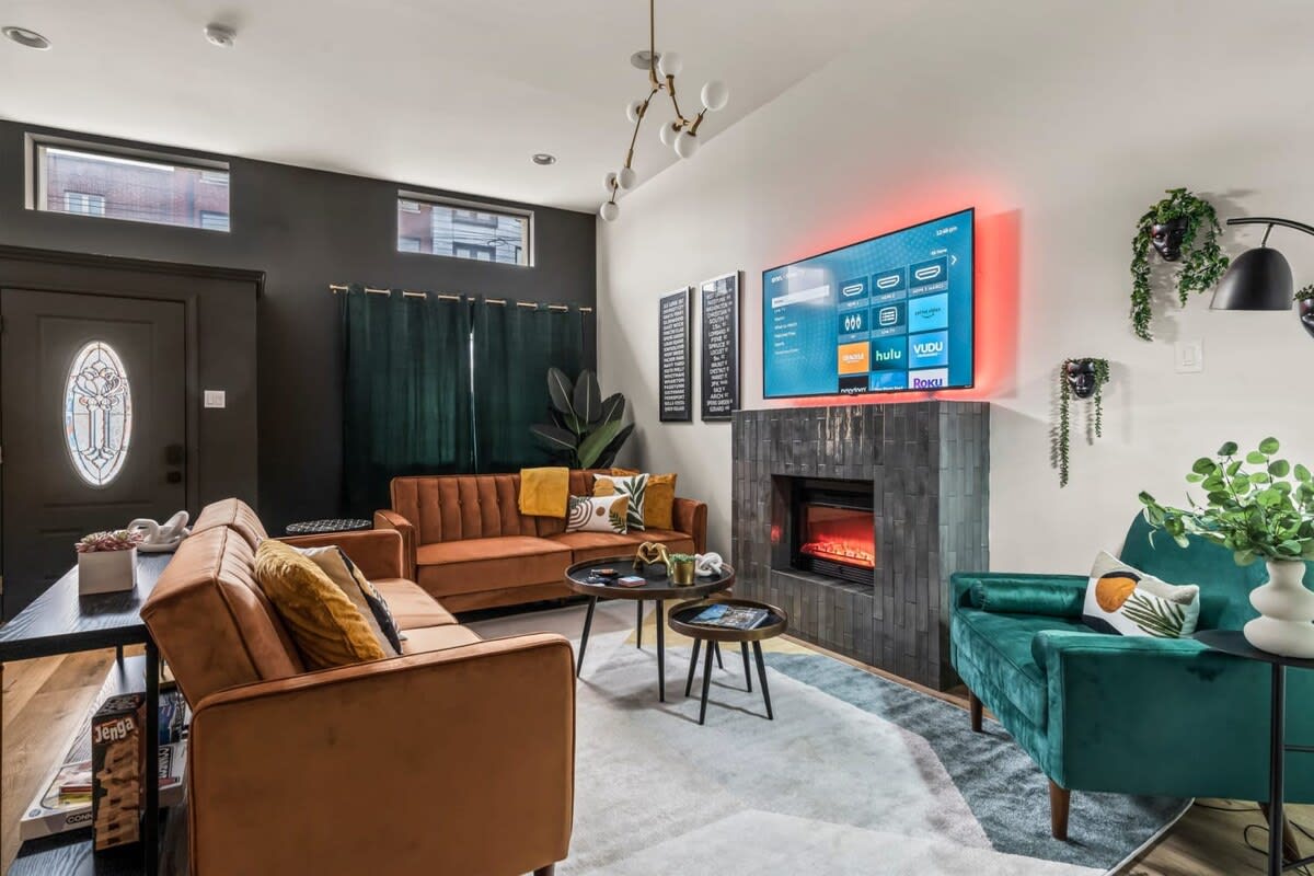 This open-concept living area is perfect for gathering with friends and family. You'll love the spacious design, cozy fireplace, and large smart TV that create an ideal environment for entertainment and relaxation.