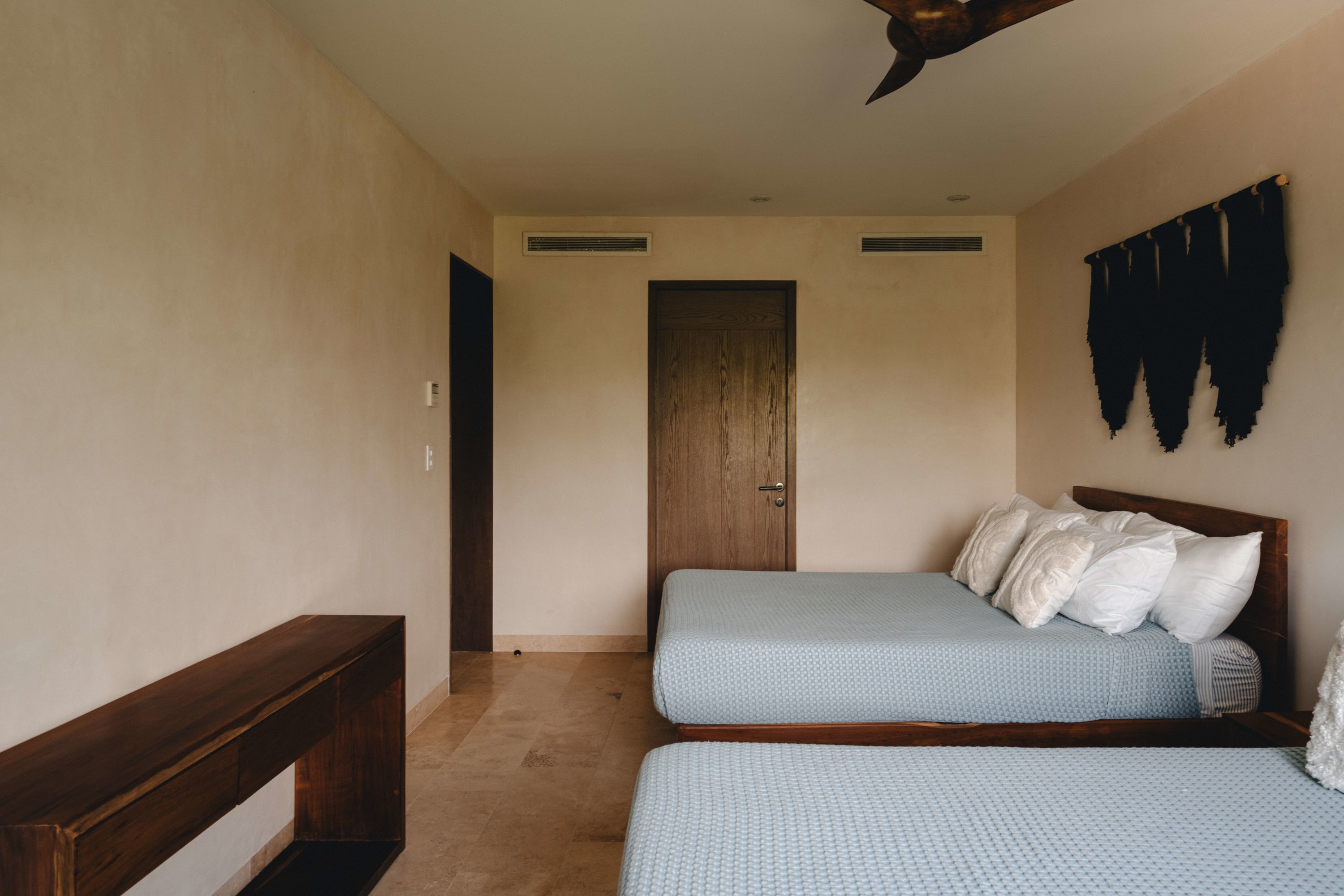 Spacious and minimalist bedroom with two beds