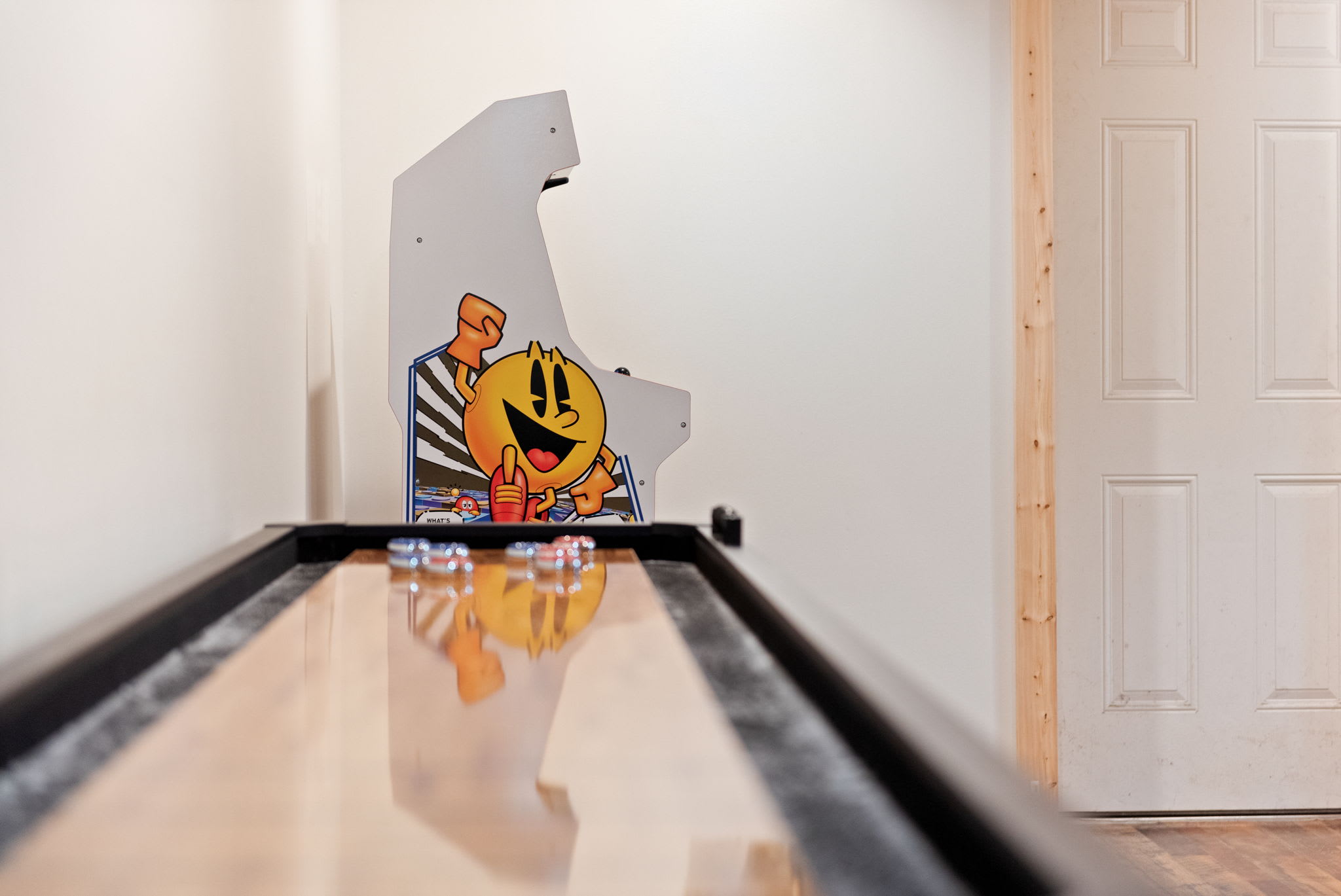 A unique angle blending the classic arcade charm of Pac-Man with the warm wooden aesthetics of the game space.