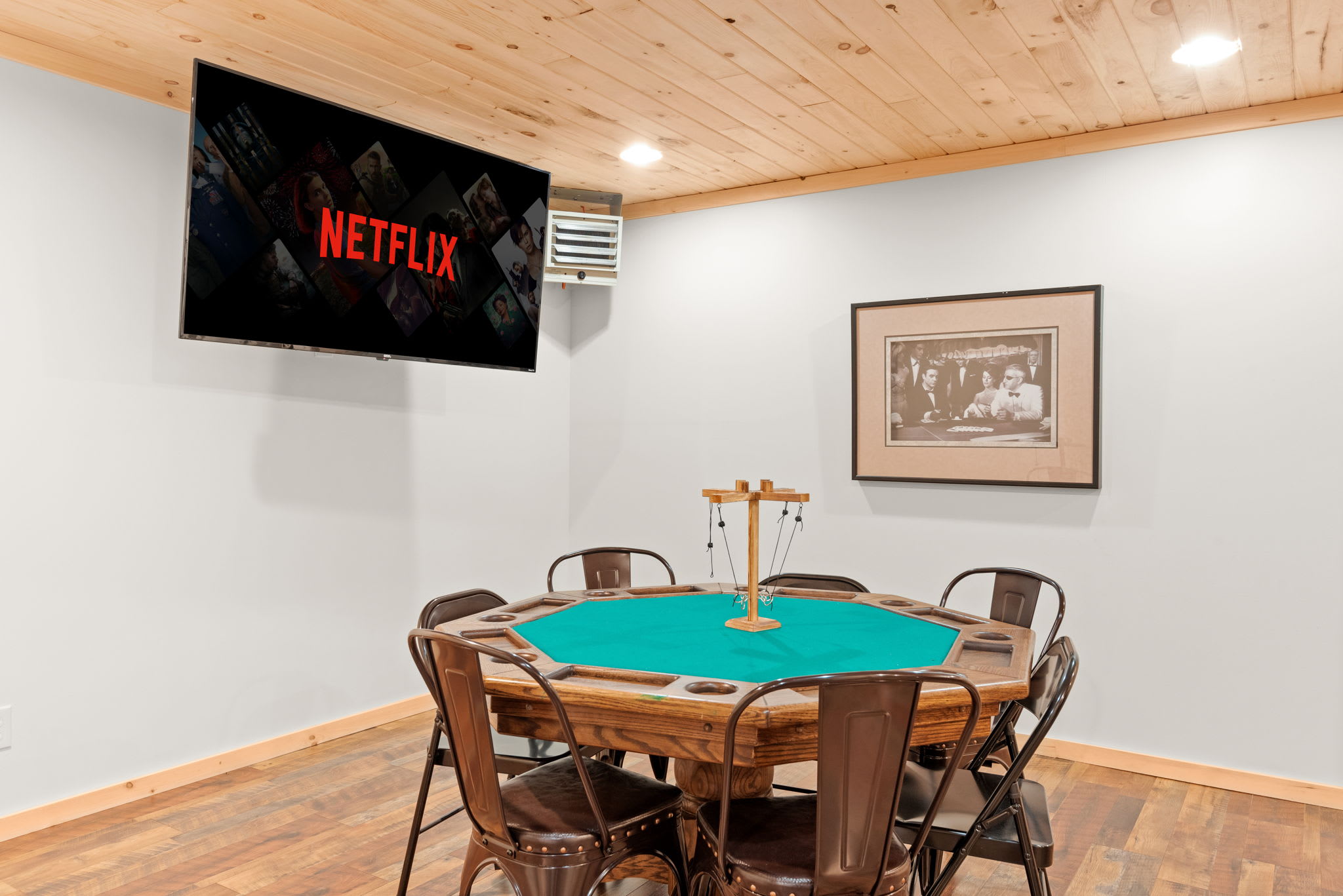 A dedicated entertainment area with a poker table, a Netflix-equipped TV, and rustic accents to set the mood.