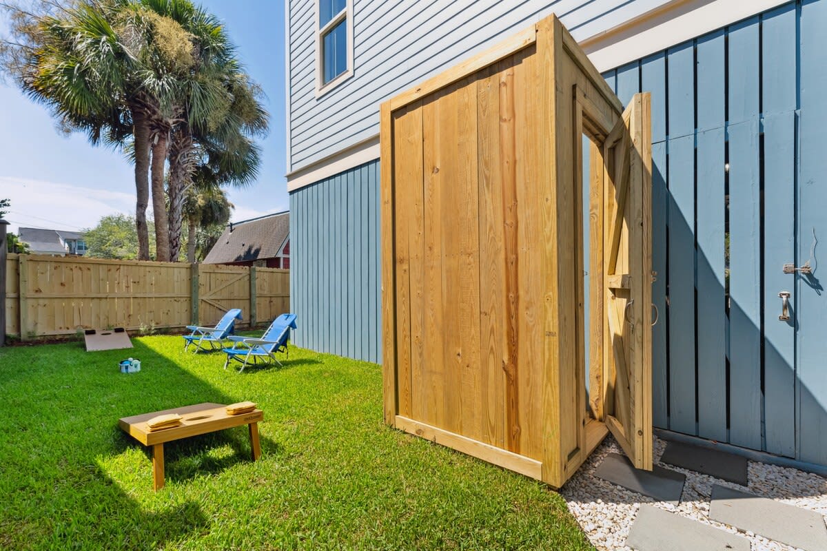 Outdoor shower and yard game space