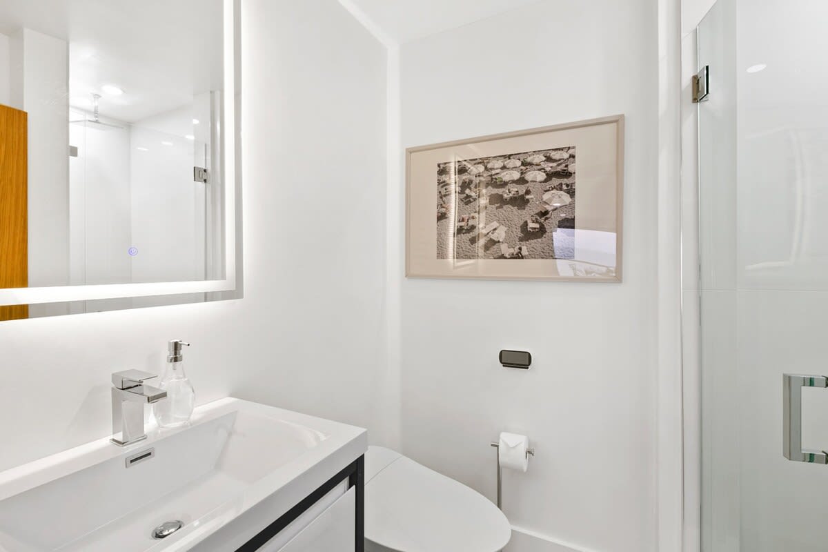 Guest bathroom with high-end vanity and toilets.