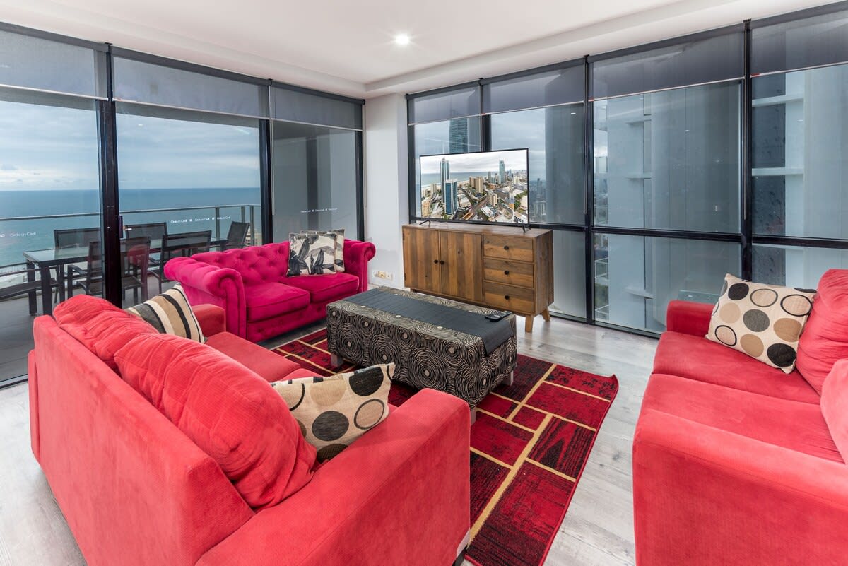 A stylishly furnished living area outfitted with TV, floor-to-ceiling windows and a reliable WI-FI 