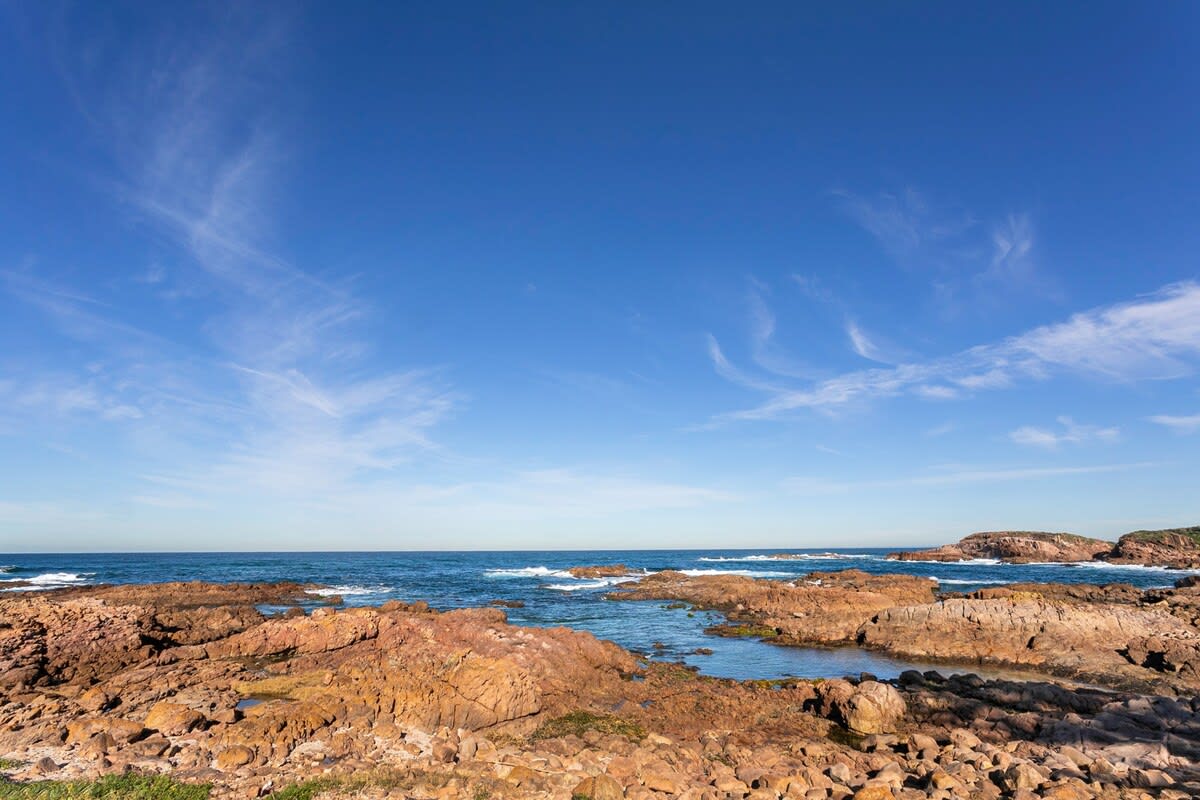 Go for a morning stroll along the beautiful rocks of Anna Bay
