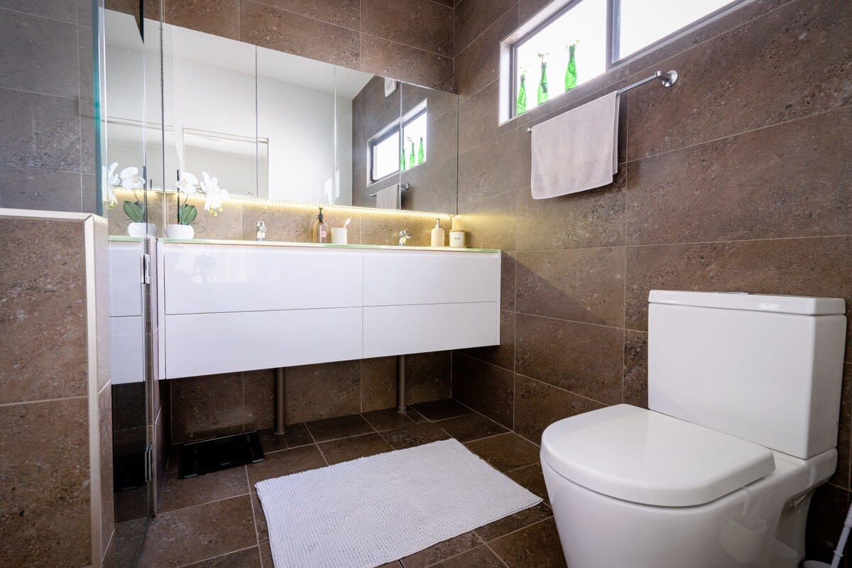 the bathroom is perfect for couples, with a luxurious double shower and twin vanities.
