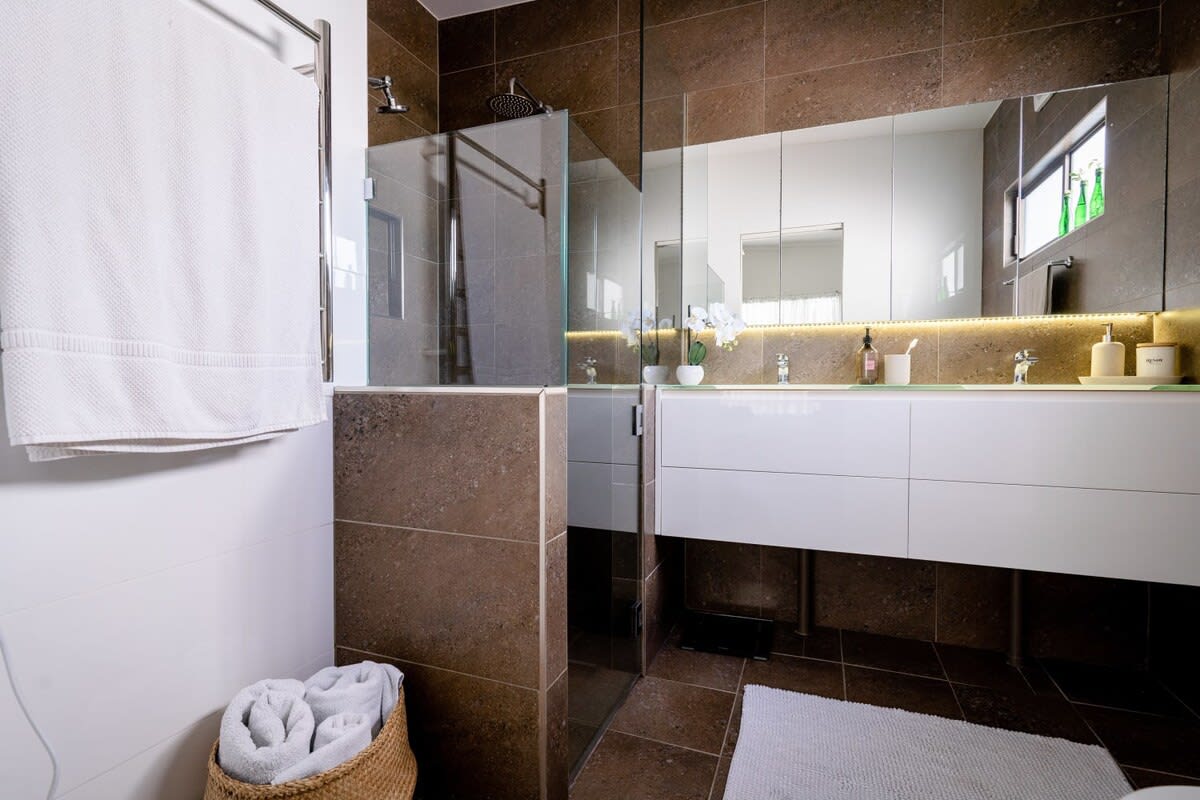 the bathroom is perfect for couples, with a luxurious double shower and twin vanities.