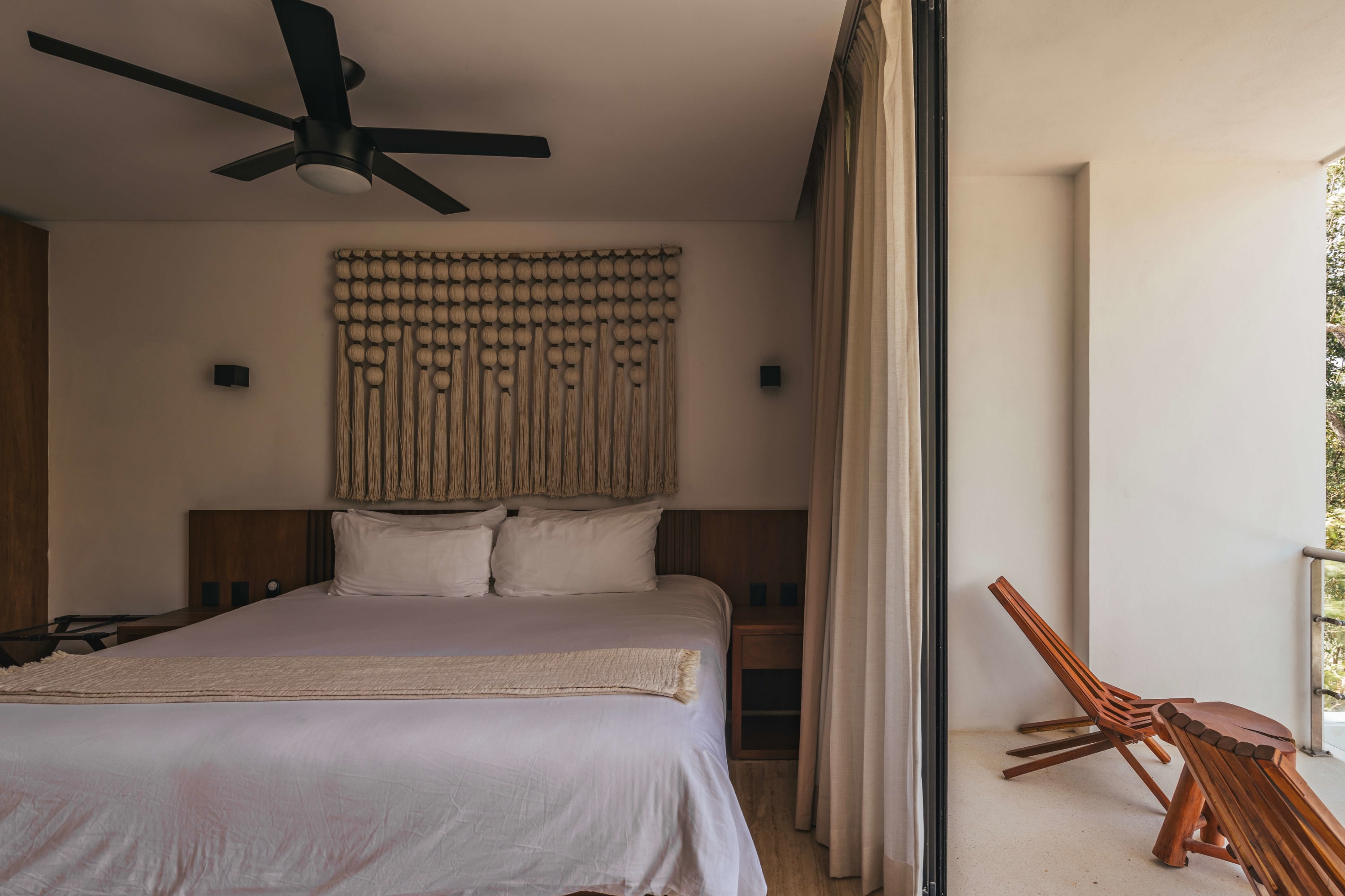 Bedroom with a king-size bed and private balcony.