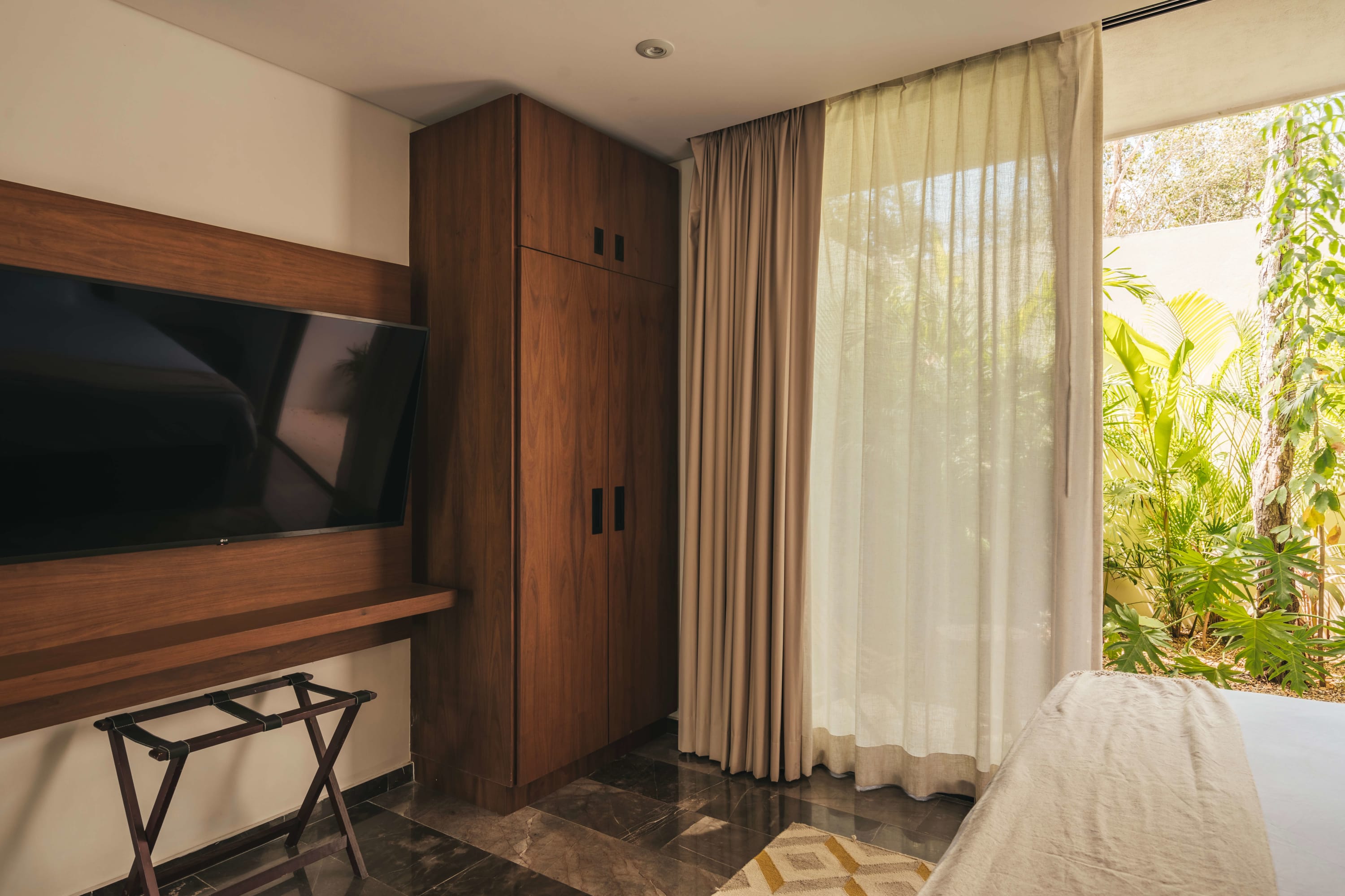 Elegant bedroom with TV and king-size bed.