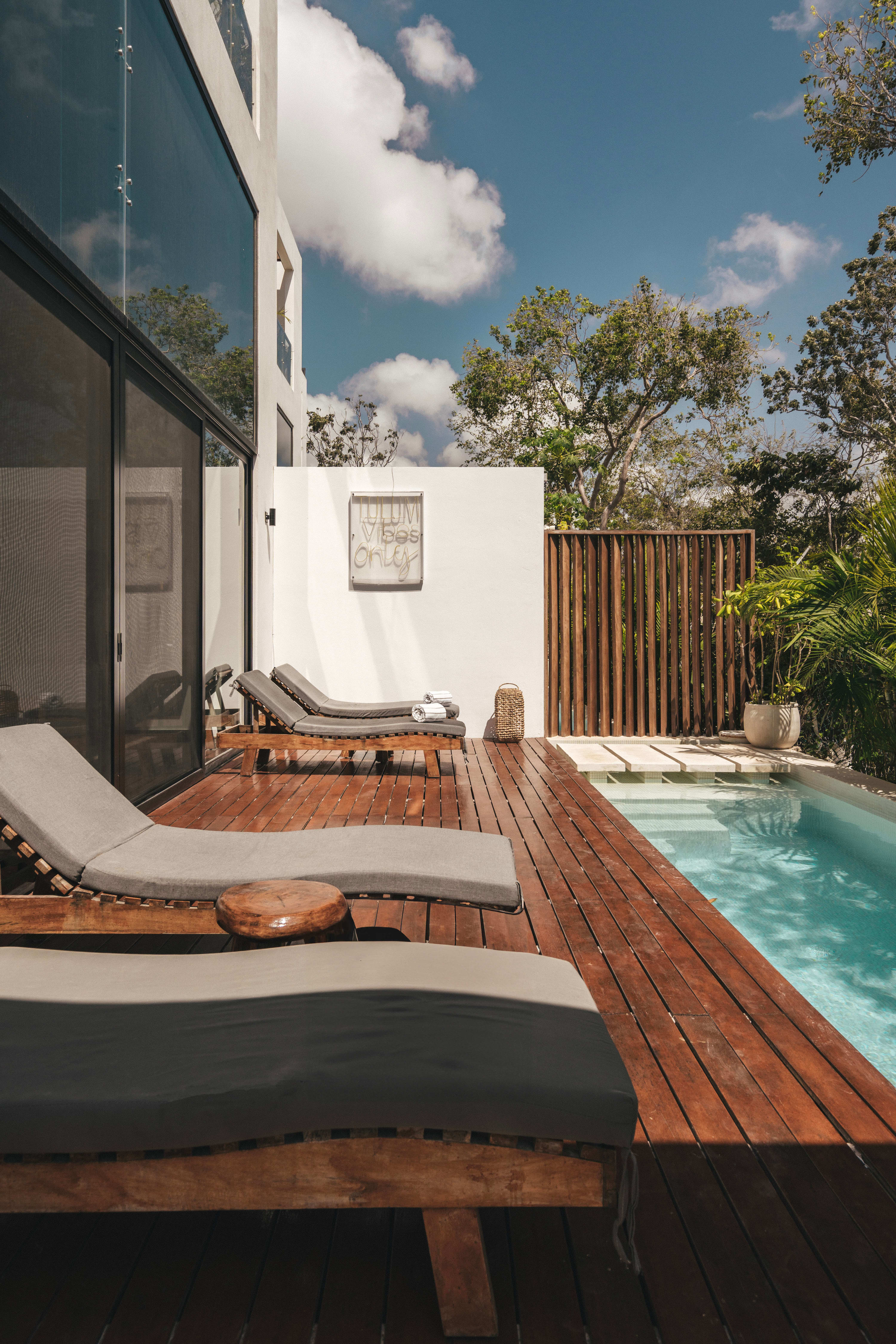 Sundeck and loungers located next to the pool.