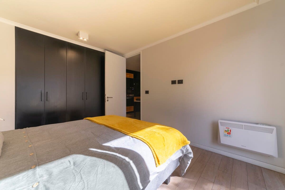 Cozy bedroom with ample storage and natural light, perfect for a relaxing stay.