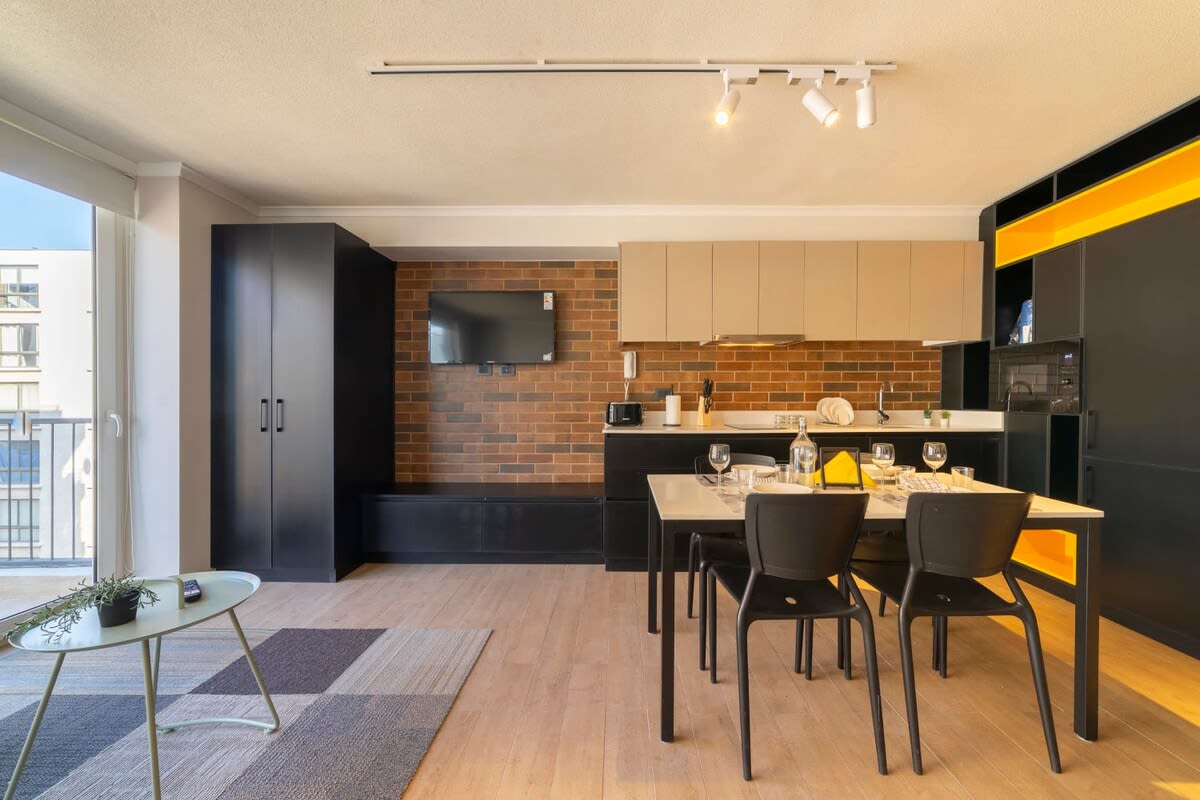 Chic and modern studio with a stylish kitchen and dining area, perfect for a cozy stay in the heart of the city.