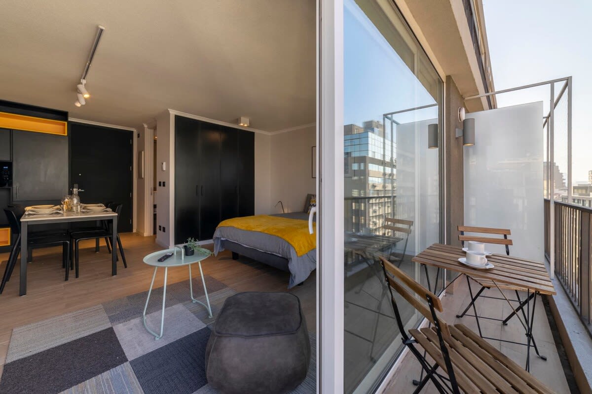Enjoy city views from your private balcony in this stylish studio, complete with cozy dining and sleeping areas.