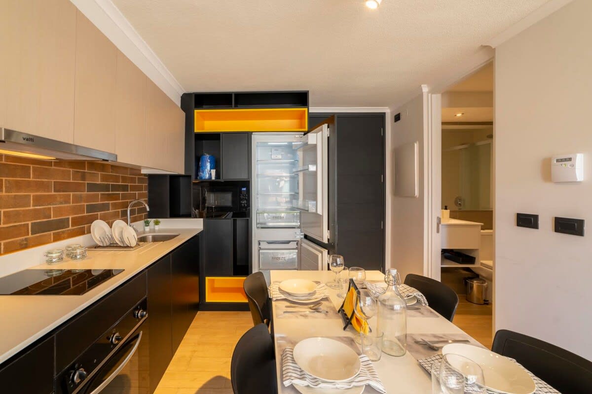 Modern kitchen with stylish dining area, perfect for cozy meals in your Chilean studio retreat.