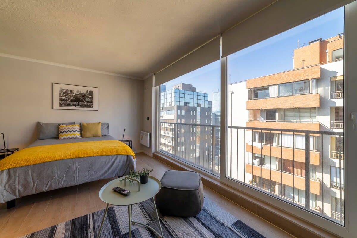 Relax in this sunlit studio with stunning city views, perfect for a cozy getaway in the heart of Chile.