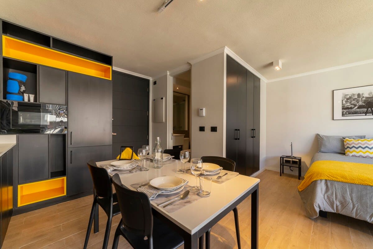 Chic and cozy studio with modern decor and vibrant accents, perfect for a relaxing stay in the heart of the city.
