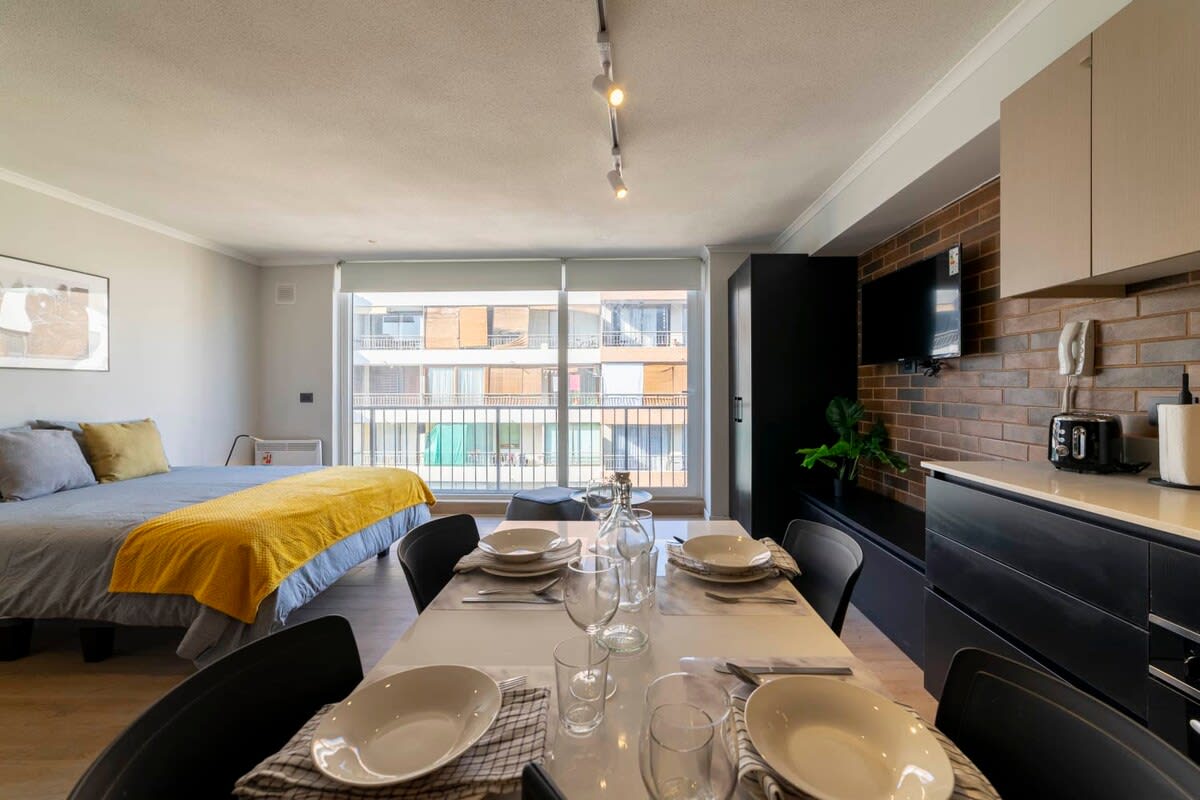 Bright and modern studio with a cozy dining area and city views, perfect for a relaxing stay.