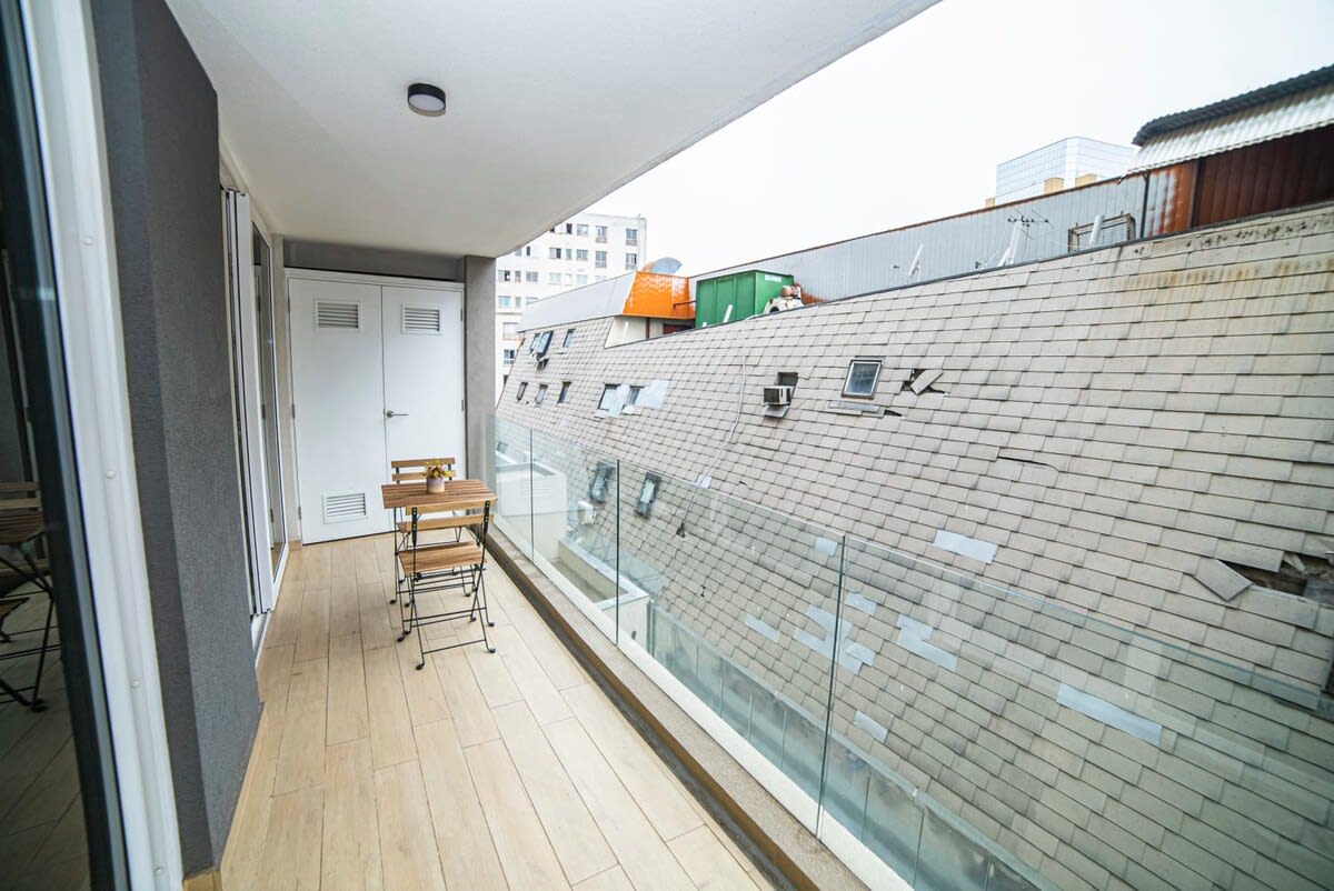 Relax on this charming balcony with a morning coffee and enjoy the vibrant urban views.