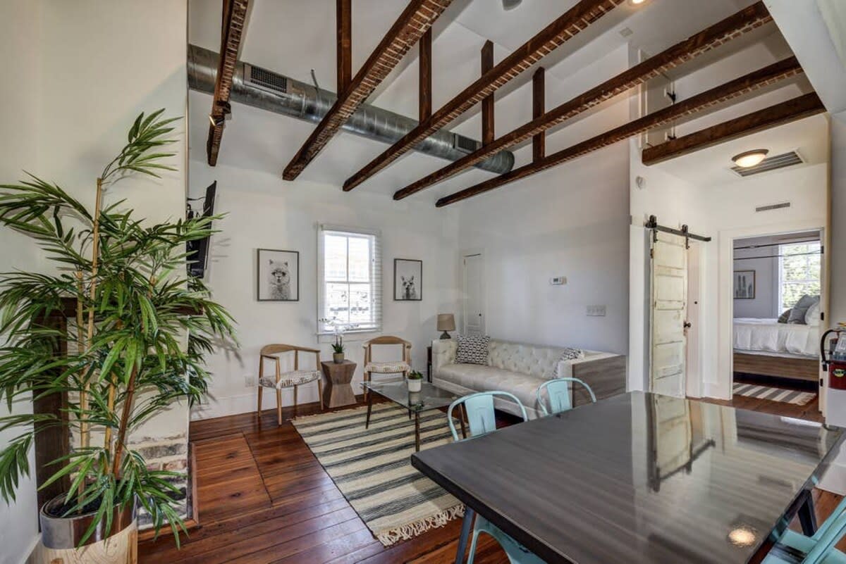 View of the living room with gorgeous exposed high beam ceilings!