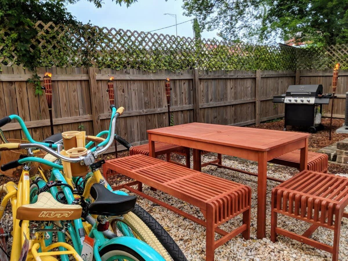 Bikes, grill and outdoor seating area behind the house (this area is shared with the downstairs unit).