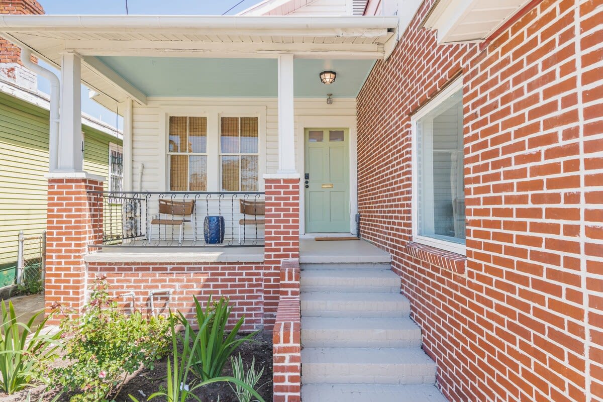 Front entrance of the home with porch seating