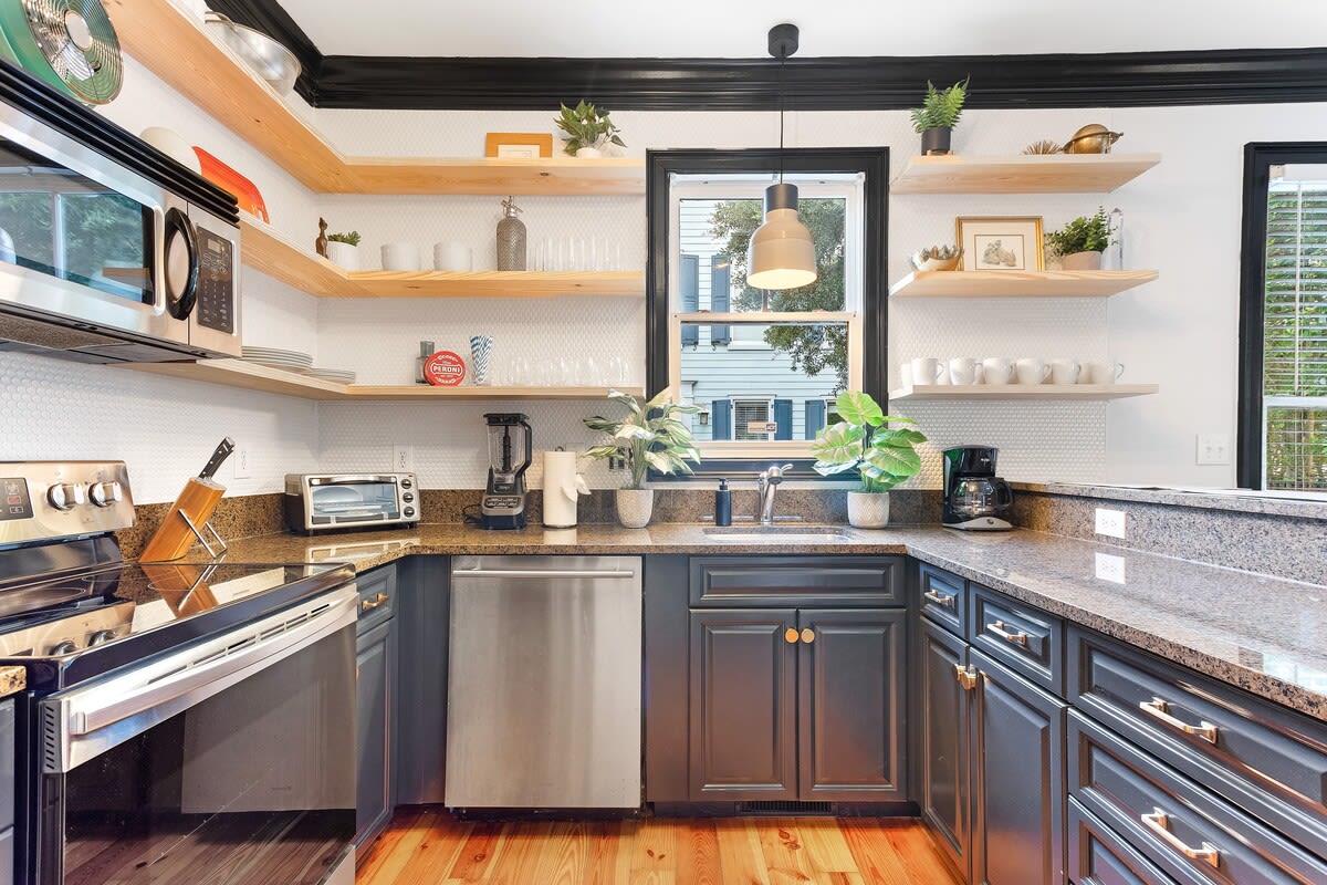 Fully stocked kitchen with stainless appliances. 