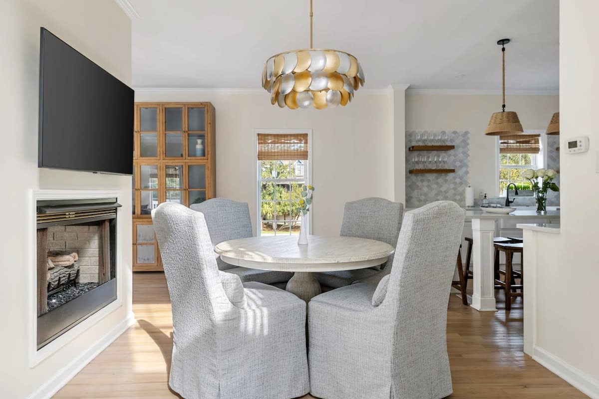 Open layout with dining table and kitchen island seating