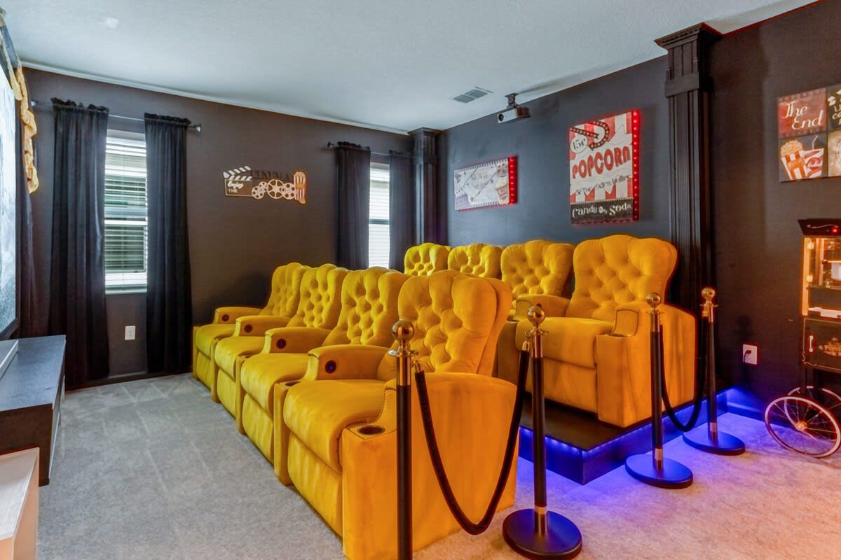 The in house loft movie theatre has a popcorn machine and cool mood lighting.