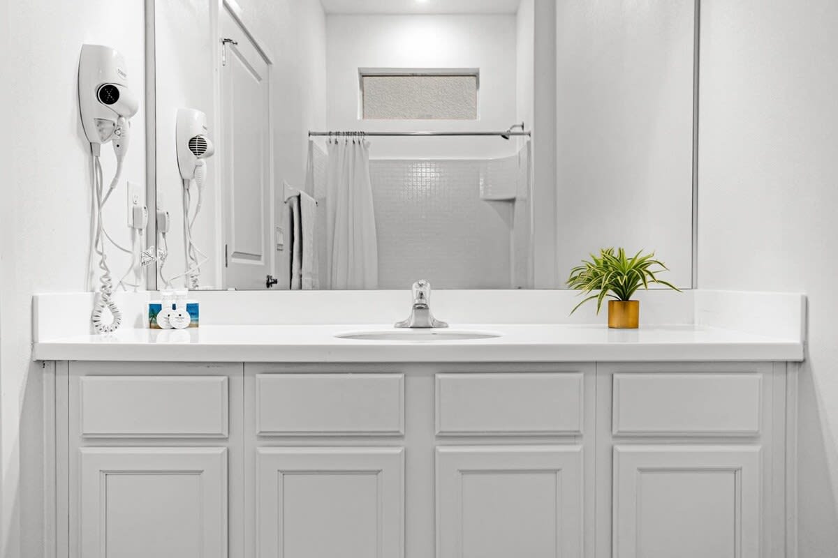 Elegant Bathroom Highlighting A Generous Mirror And Functional Design