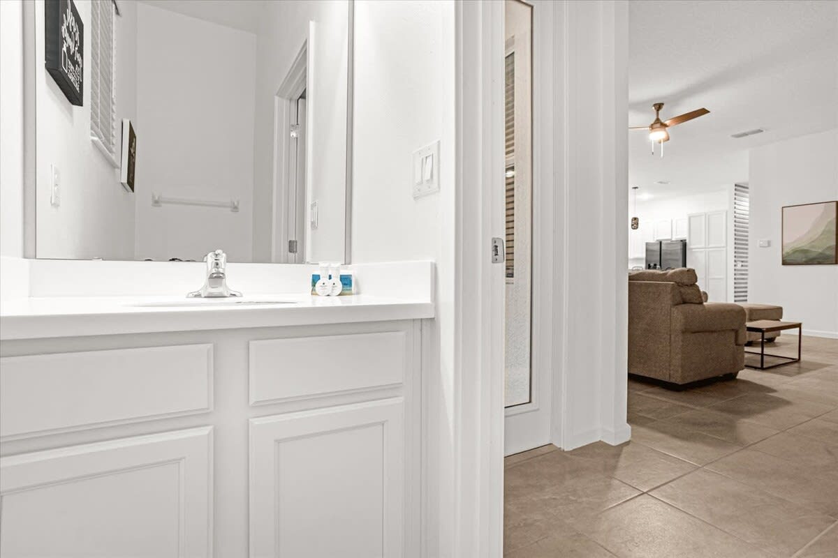 Elegant Bathroom Highlighting A Generous Mirror And Functional Design