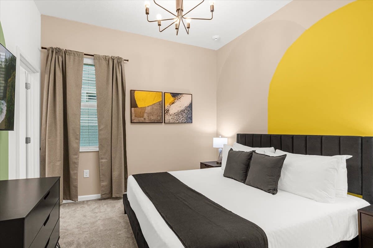 King Bed Framed By Contemporary Design And Complemented By A Smart TV