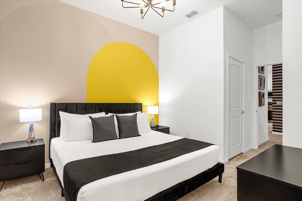 King Bed Framed By Contemporary Design And Complemented By A Smart TV