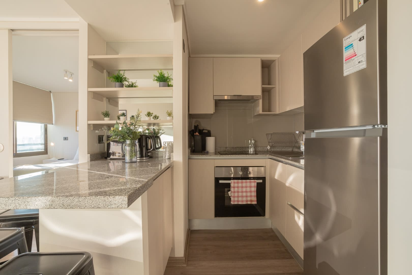 Sleek and modern kitchen with stainless steel appliances and granite countertops, perfect for cooking and entertaining.