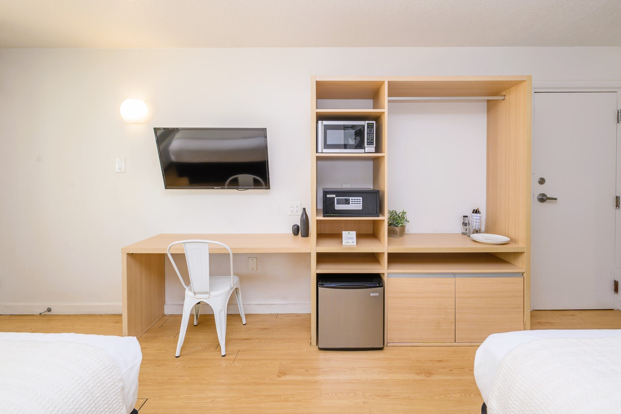 Suite includes a kitchenette with a mini fridge, microwave over, cutlery and dishes.