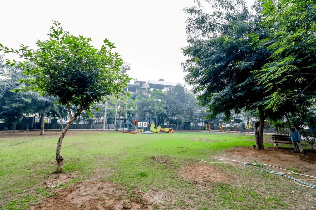 A picturesque view of the park, with lush greenery, walking paths, and a serene natural setting.