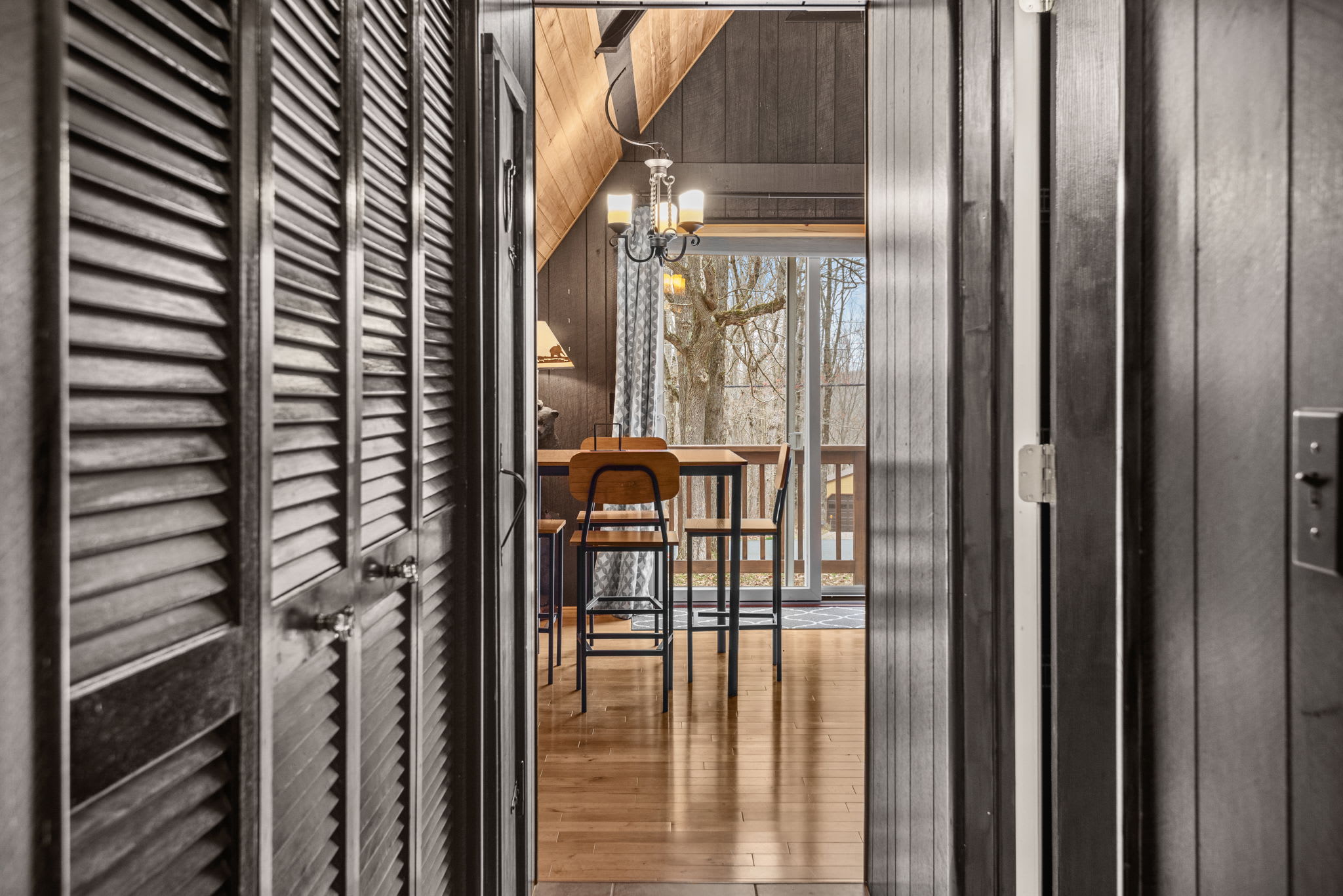 A cozy and inviting hallway opening into the warm and rustic dining space.