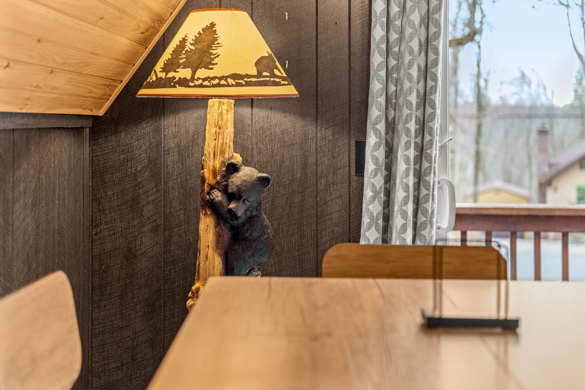 A charming detail featuring a bear cub lamp, adding a whimsical touch to the cabin’s rustic ambiance.