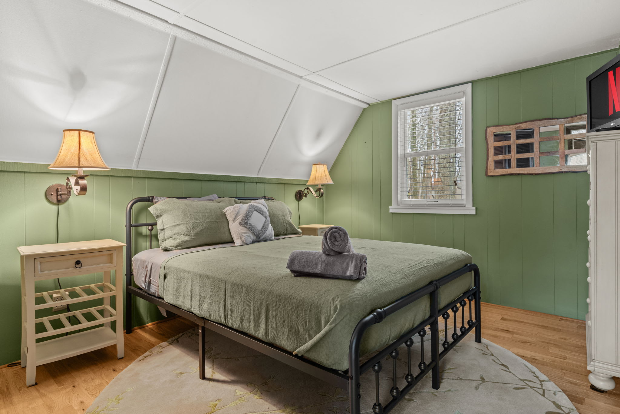  A cozy and stylish bedroom with a comfortable bed, soft lighting, and unique wooden decor.