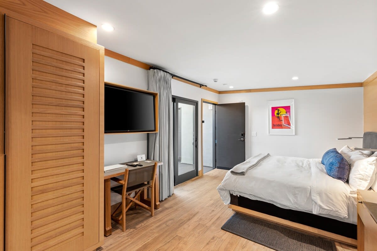 A King sized bed fully made with luxurious linens for a dreamy sleep