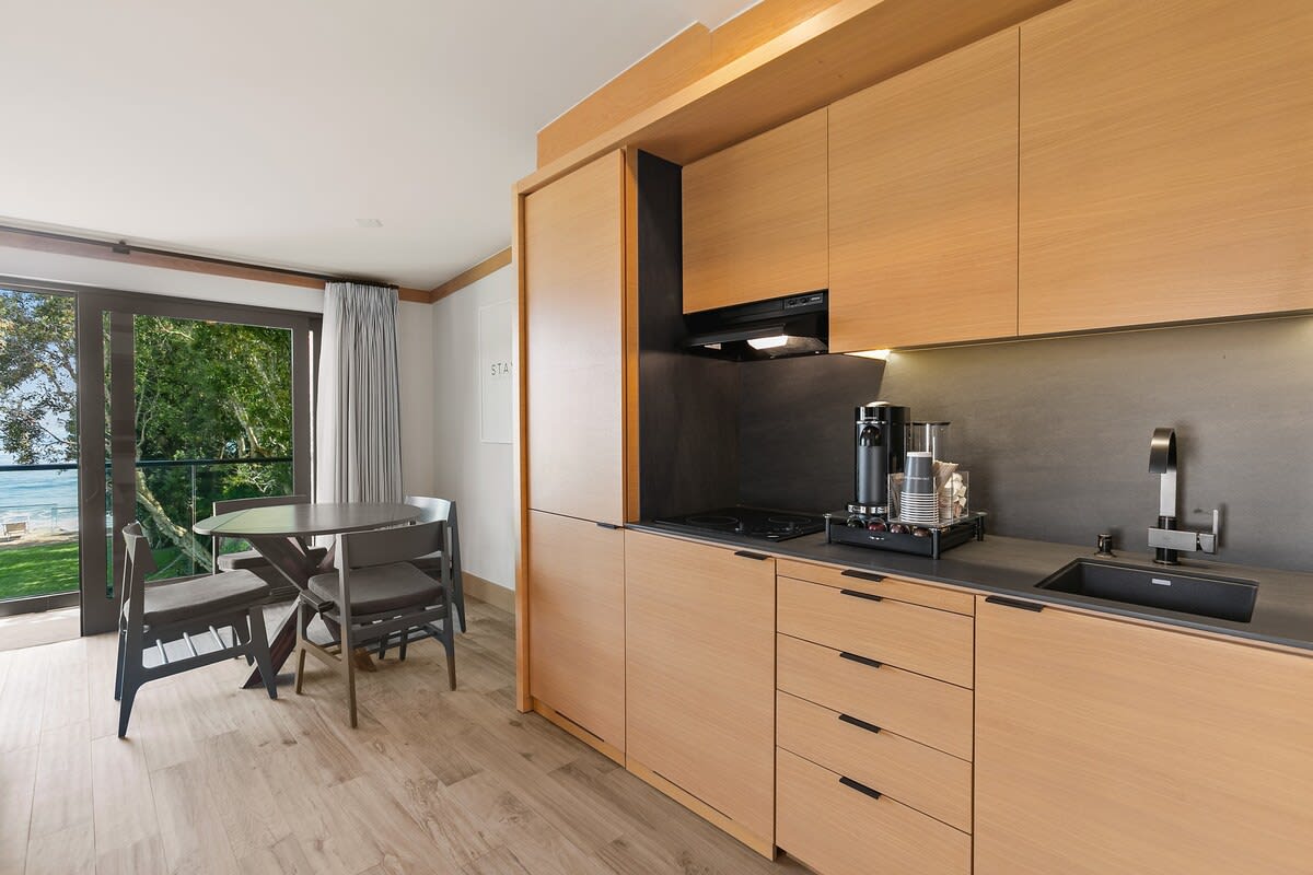 Kitchenette with mini-fridge and freezer, cooktop, Nespresso Vertuo coffee station with pods, toaster oven, iron tea kettle and Ninja blender.
