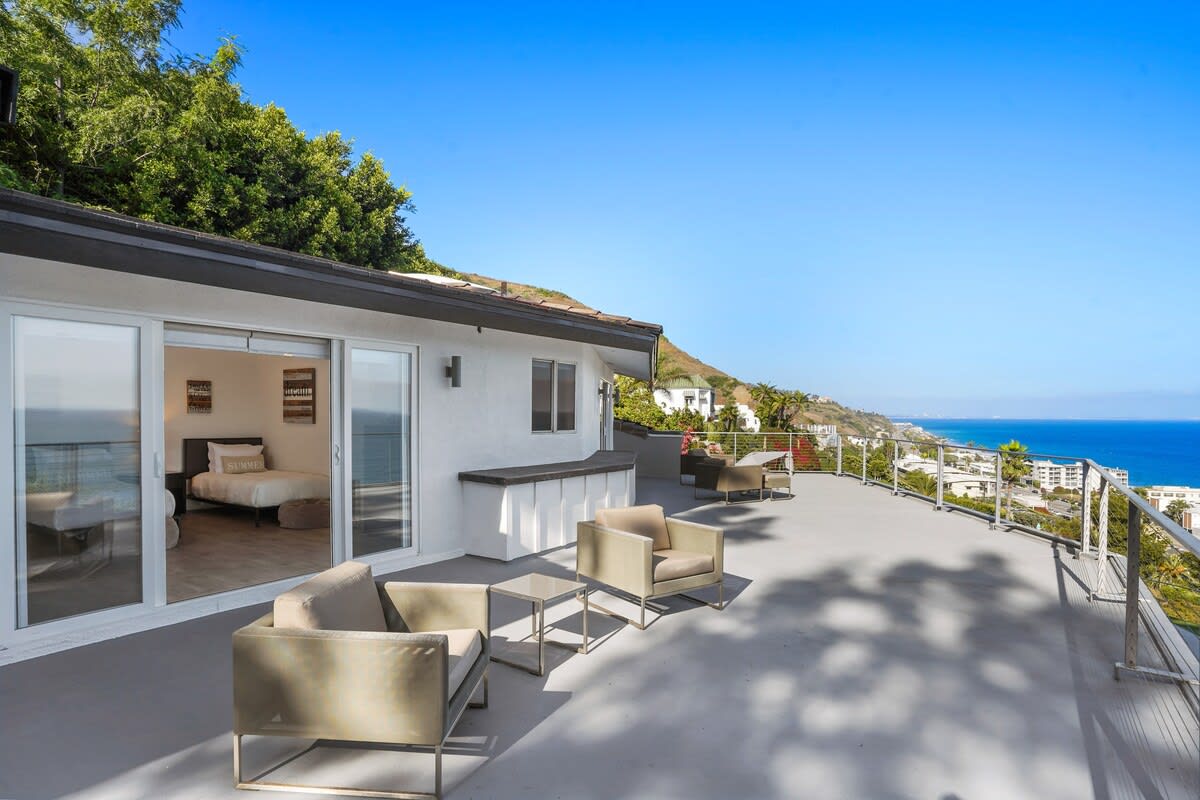 Step onto the private outdoor sitting area of the second bedroom.