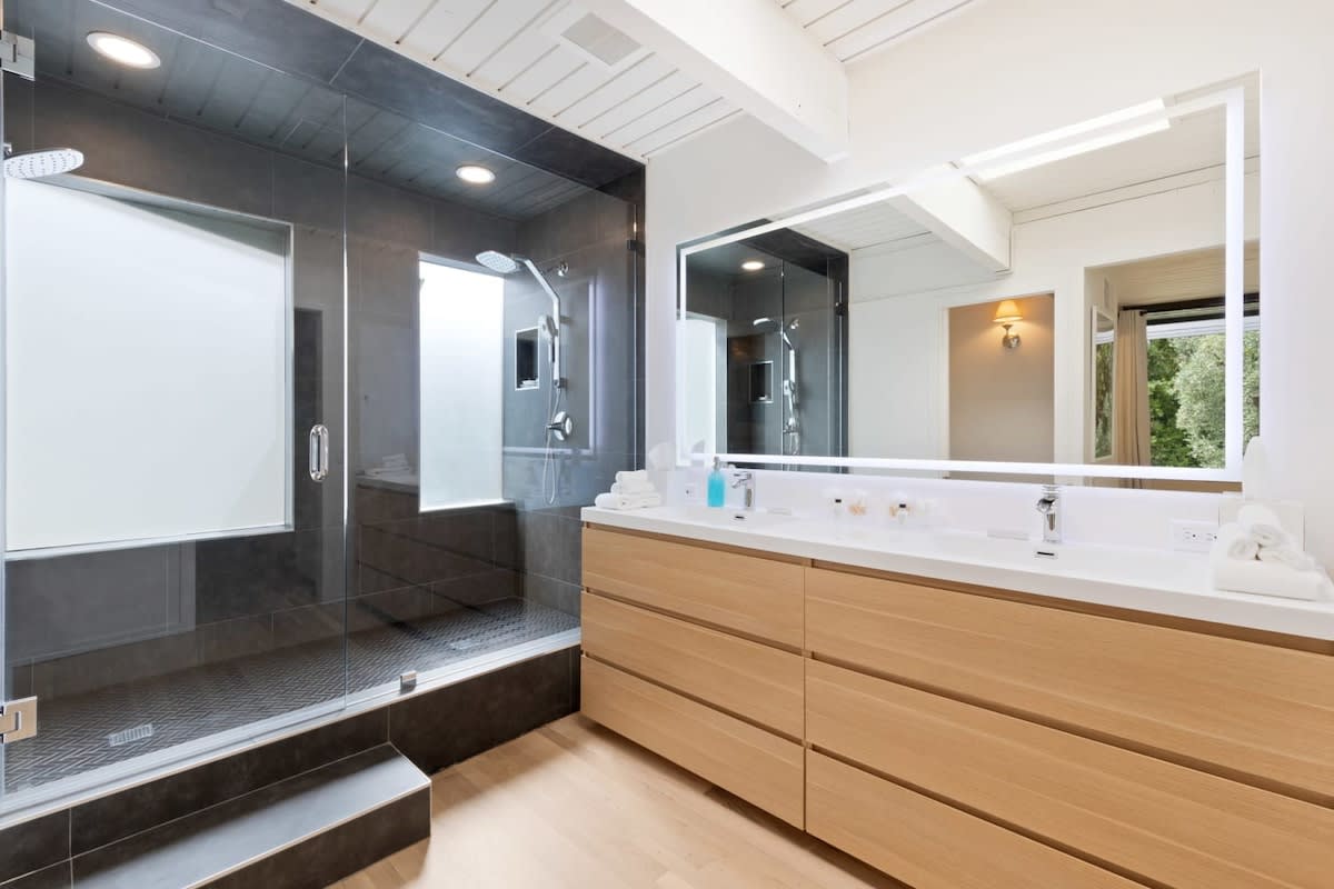 Newly remodeled primary bathroom with a spacious rain shower