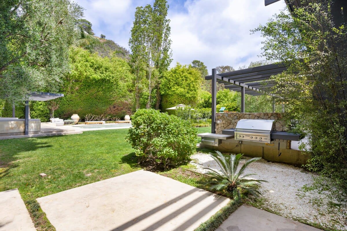 Take a dip in the gorgeous pool, conveniently located next to the outdoor BBQ and seating area.
